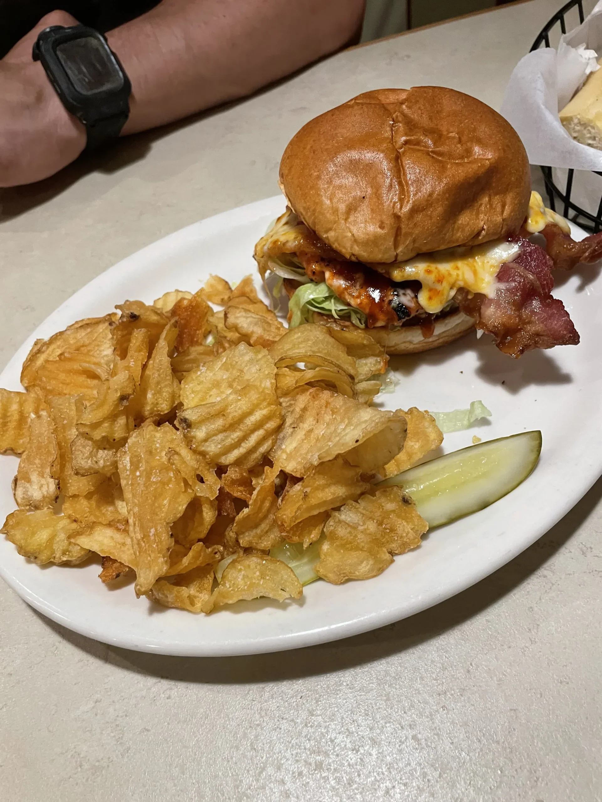 Tomato Brothers burger and chips on plate.