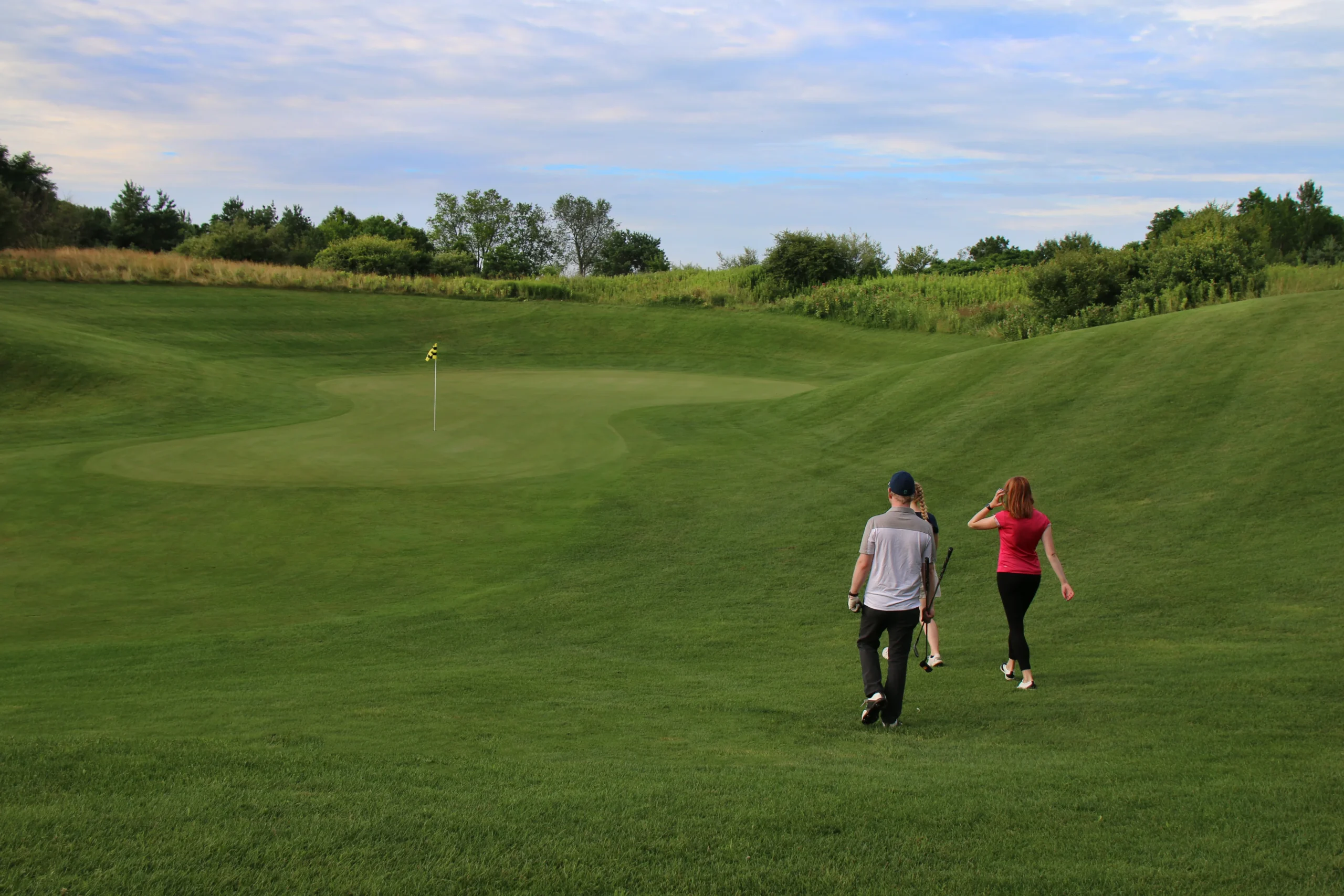 Two people walking on the fairway at the Majestic at Lake Walden.