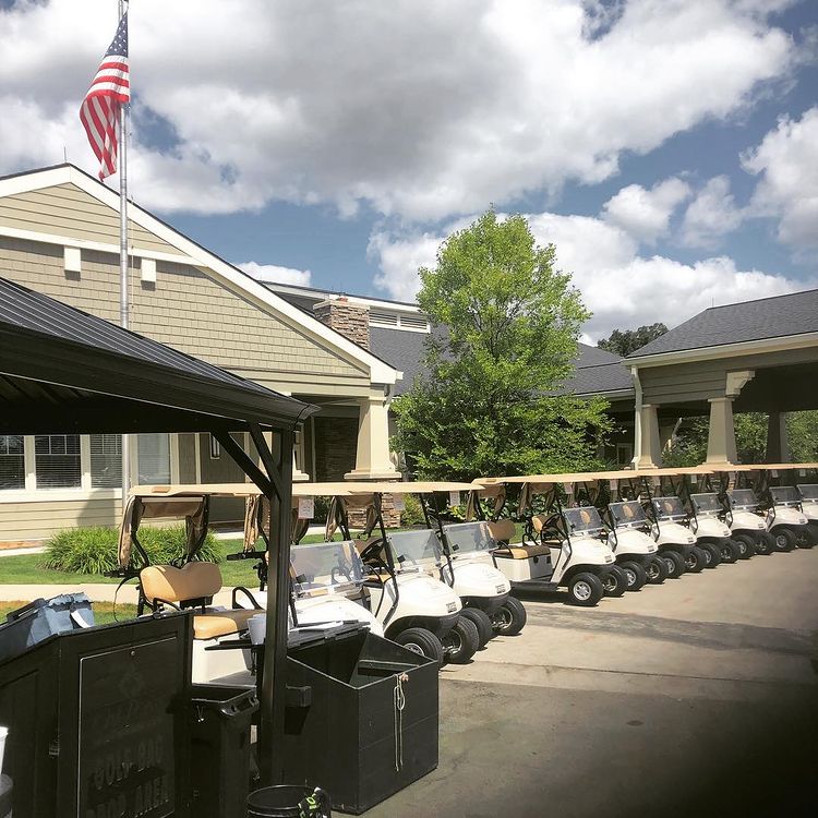 Golf carts lined up in front of Oak Pointe