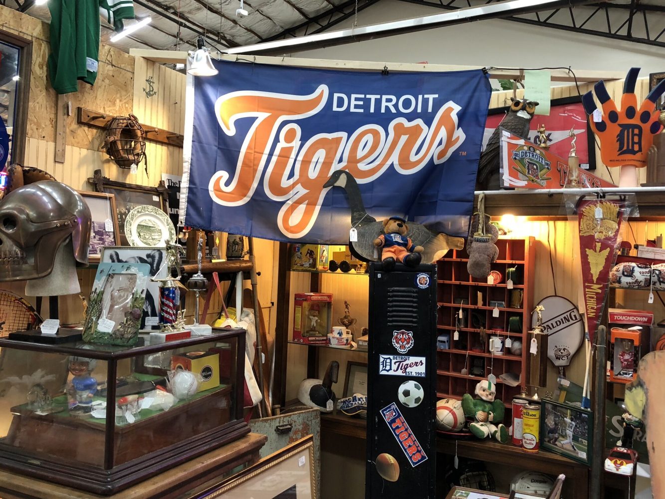 a detroit tigers flag hanging among other memorbilia