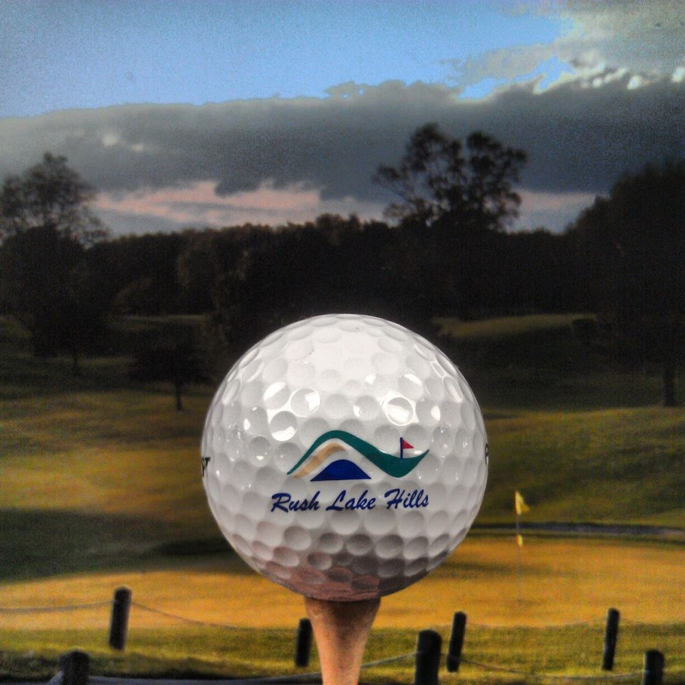 close up of golf ball with Rush Lake Hills Golf Club logo
