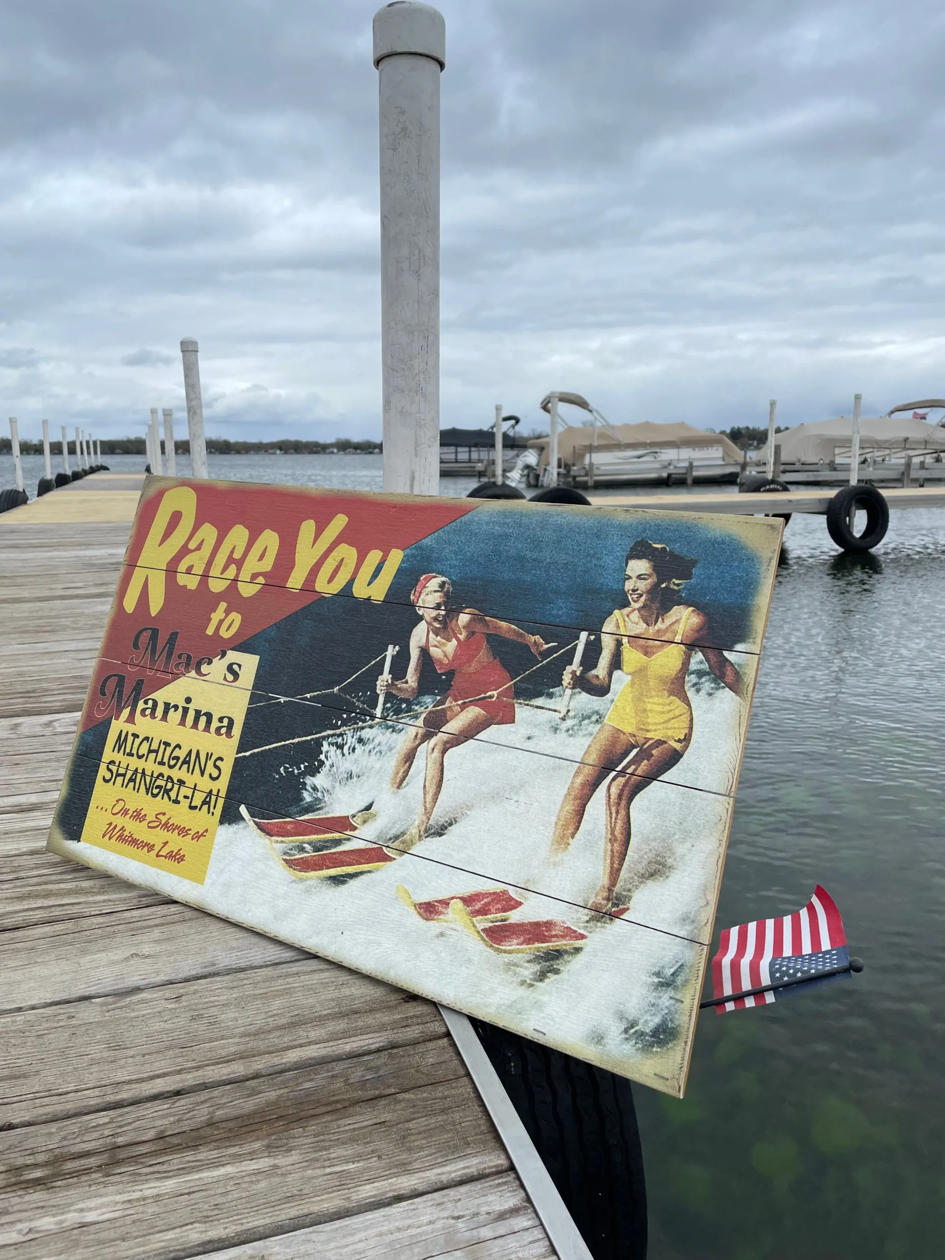 Sign on the doc at Mac's Marina on a cloudy day that says