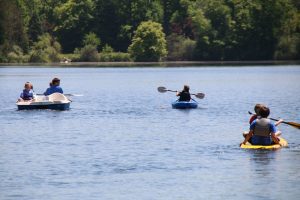 Kids kayaking on a lake