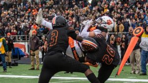 high school football players catching a pass