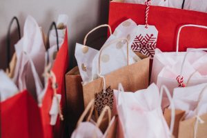 Red, brown, and white gift bags with tissue paper