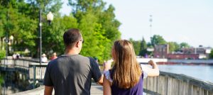 Father and daughter walk along bridge downtown brighton