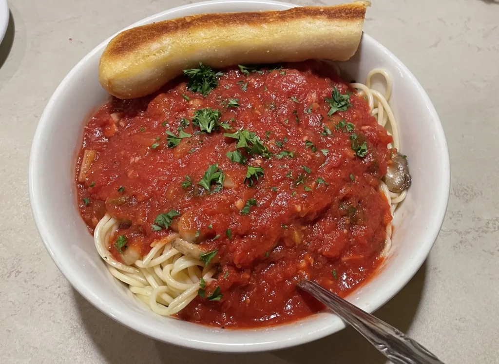 towering bowl of spaghetti pasta with homemade marinara sauce
