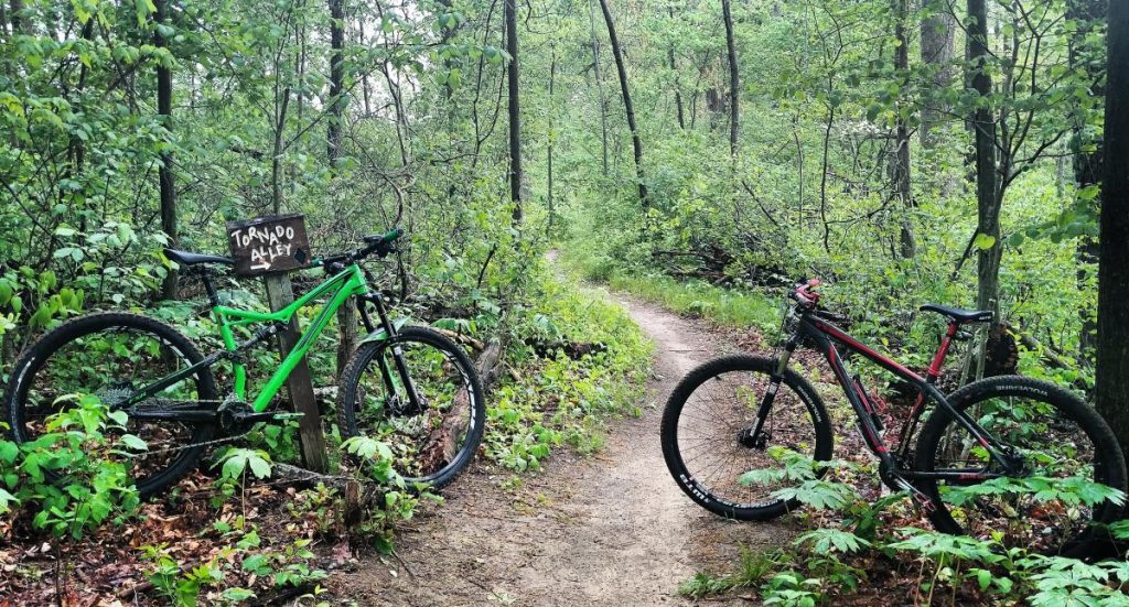 Two Bikes parked facing eachother.