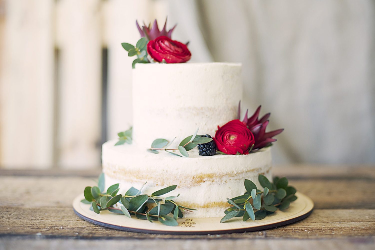 white wedding cake on wooden table