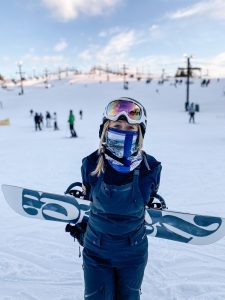a woman with a snowboard