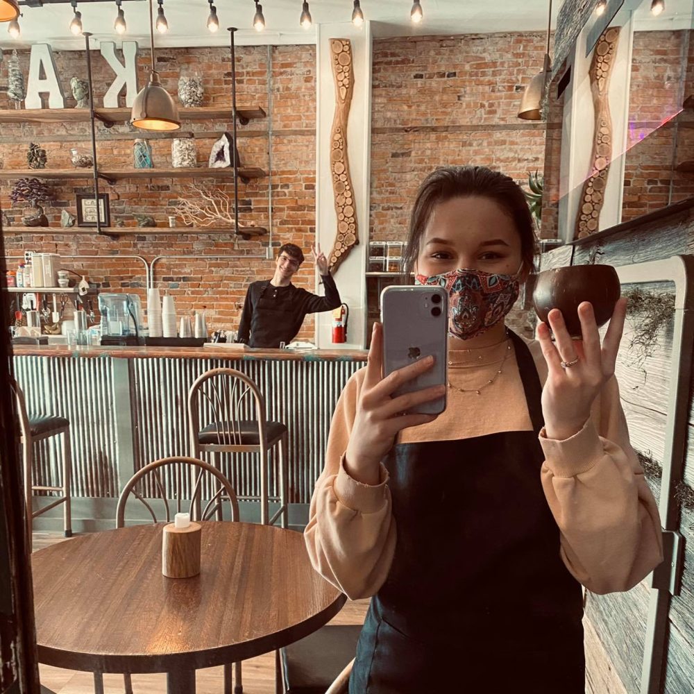 Person taking a selfie in front of mirror holding a drink at Weaver's Kava House
