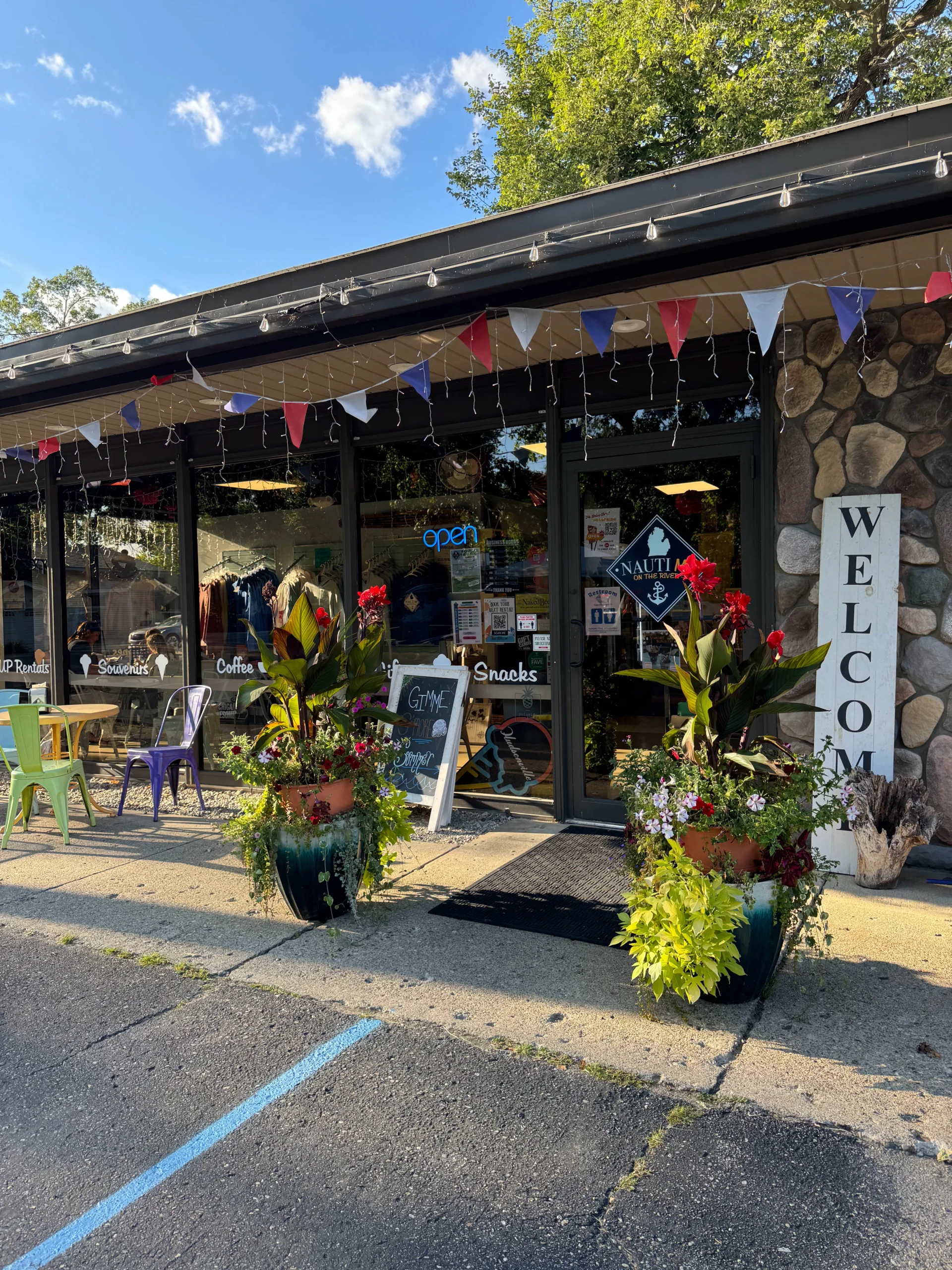 NautiMi on the River storefront during fourth of july on sunny day in Pinckney.