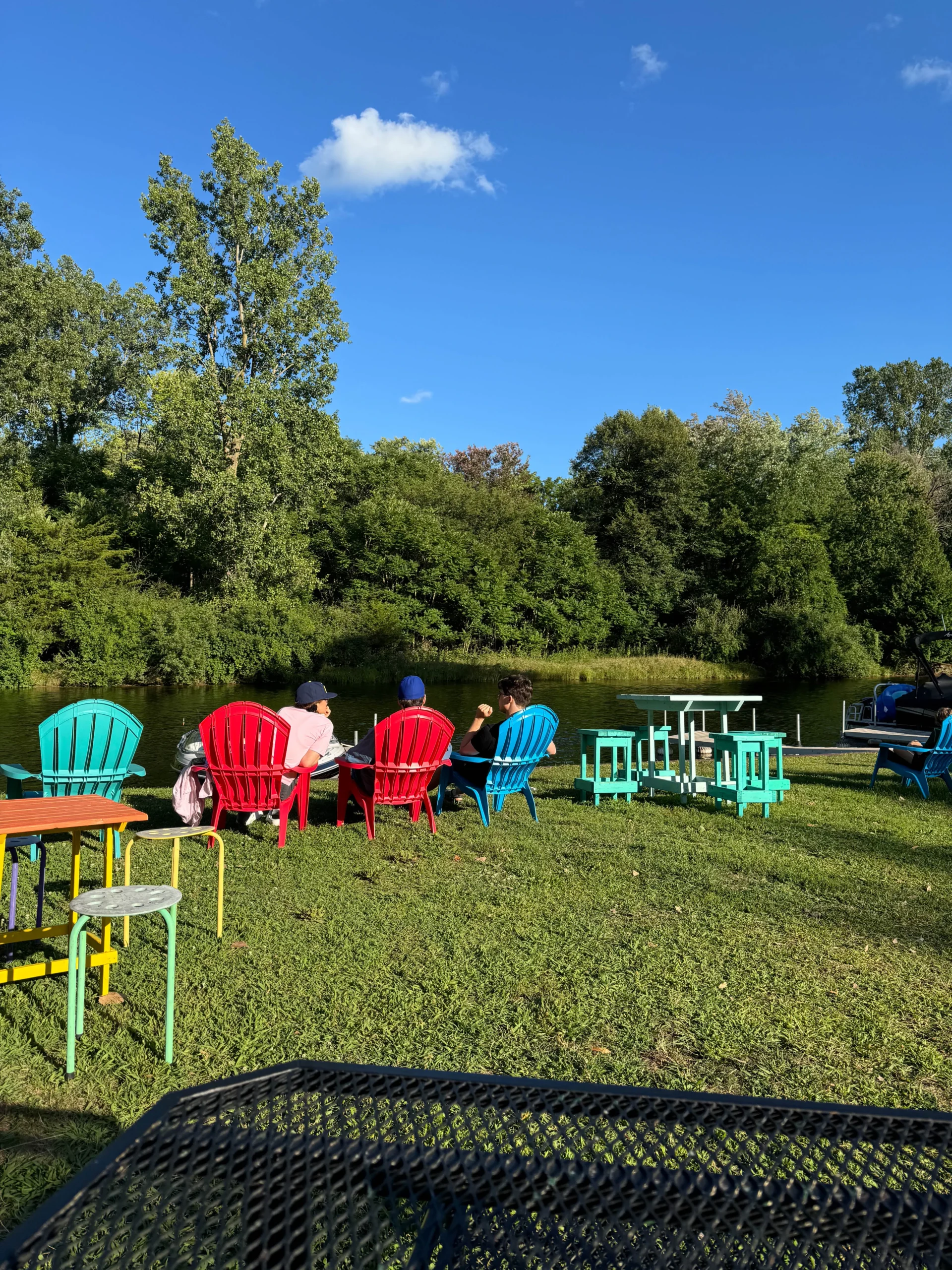 NautiMi on the River rierfront seating in colorful chairs in Pinckney.
