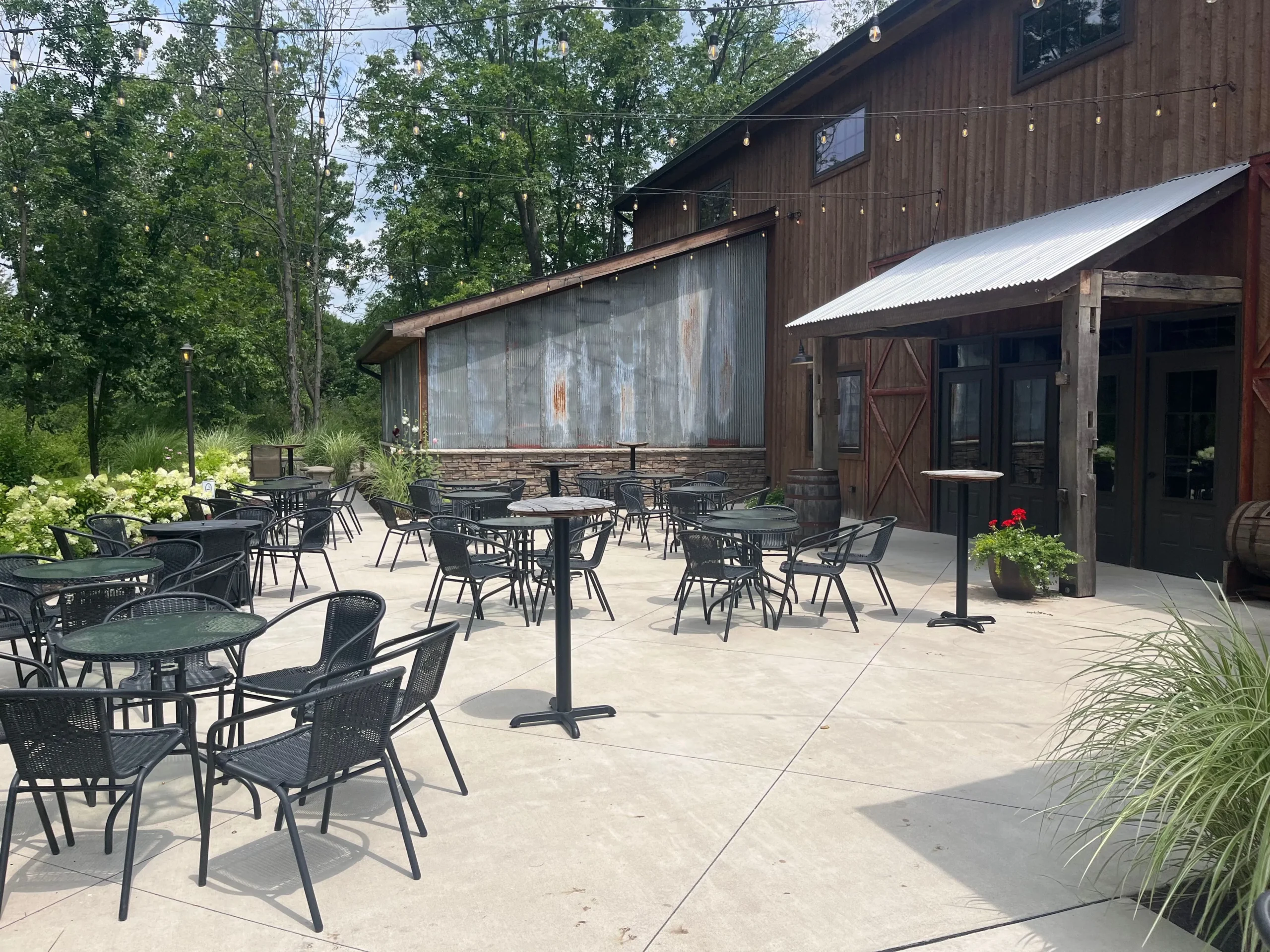 Tandale Nature Barn outdoor patio and brown barn in back.