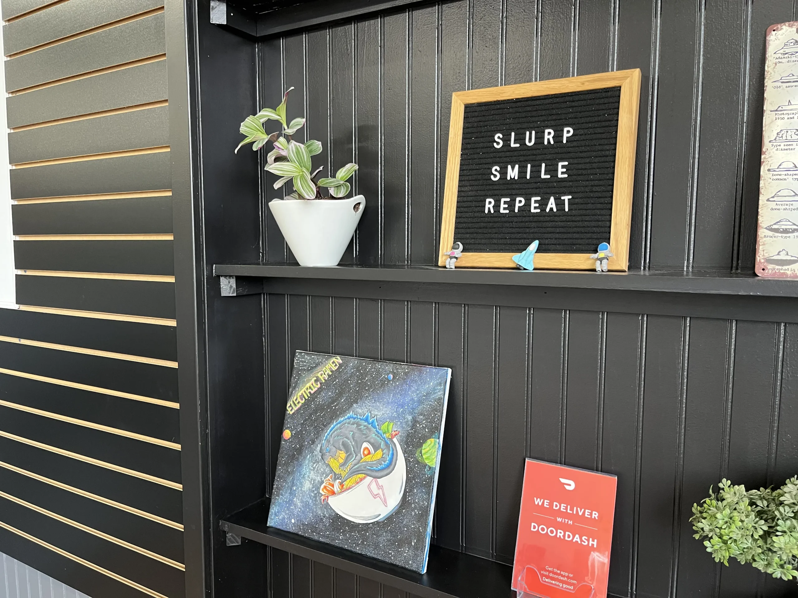 Electric Ramen shelf with decorations in Brighton location.