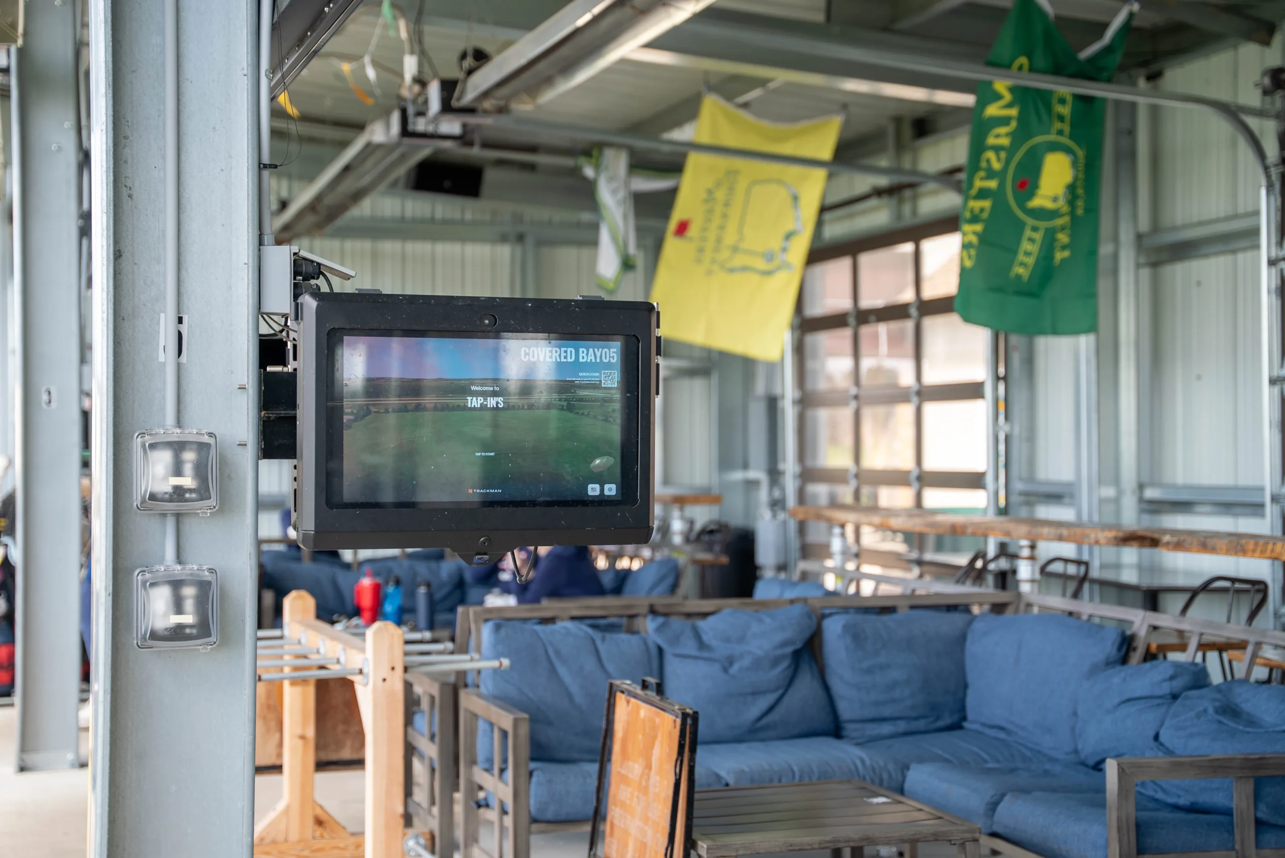 Tap-In's Range outdoor bays for golf couch area.