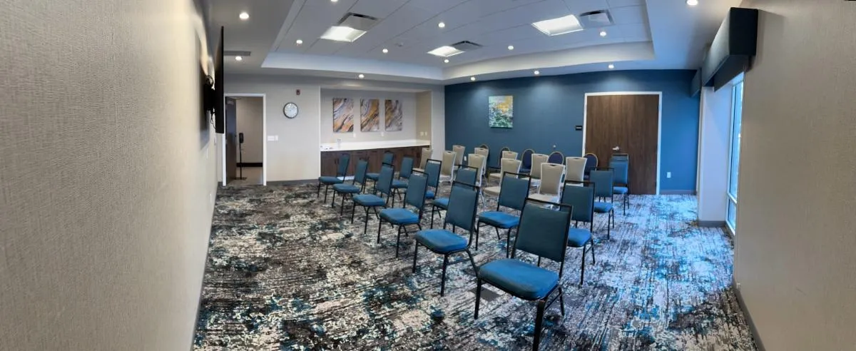Hampton Inn howel Meeting Space panoramic view with chairs set up theater style.