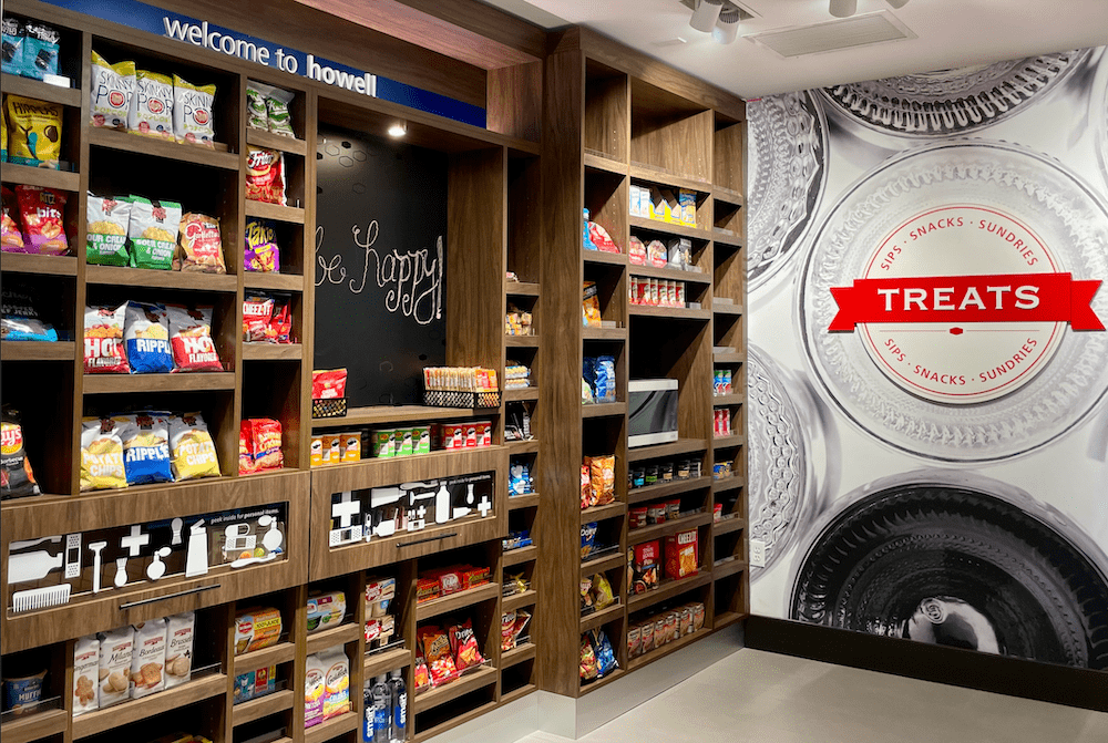 A big brown pantry within a hotel contains various snacks and products