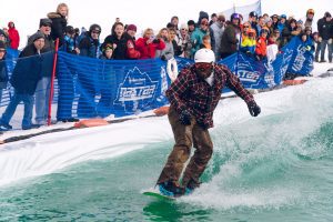 man snowboarding at slush cup at mt brighton
