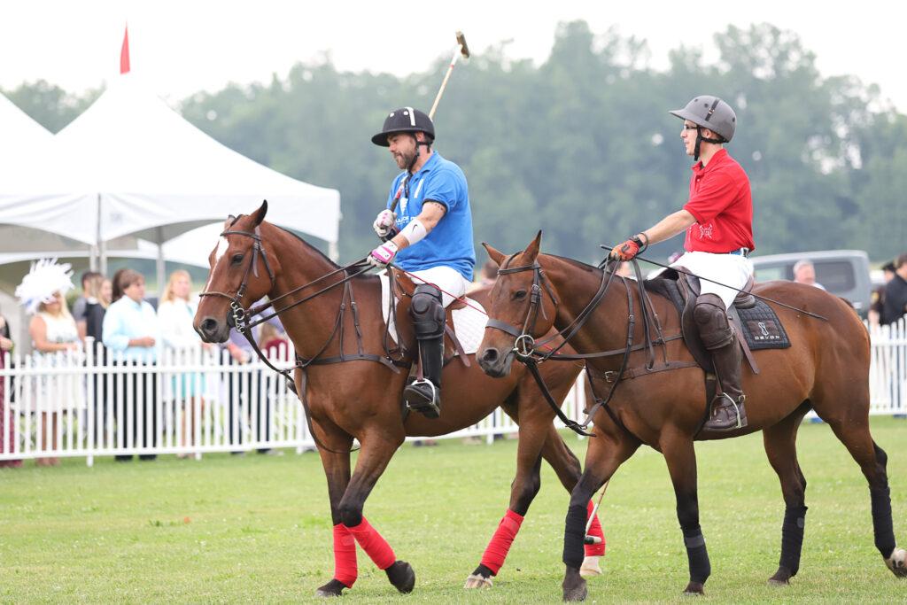Polo players sitting on horses playing a polo match in Hartland