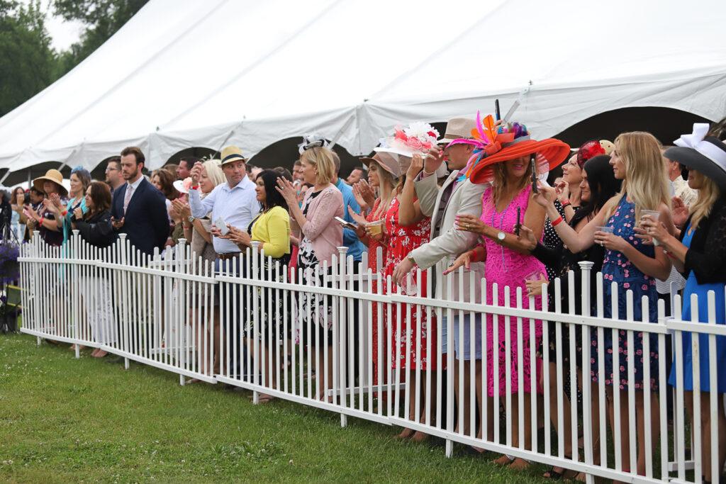 Hartland Polo Classic fans cheering on the polo match in fabulous hats