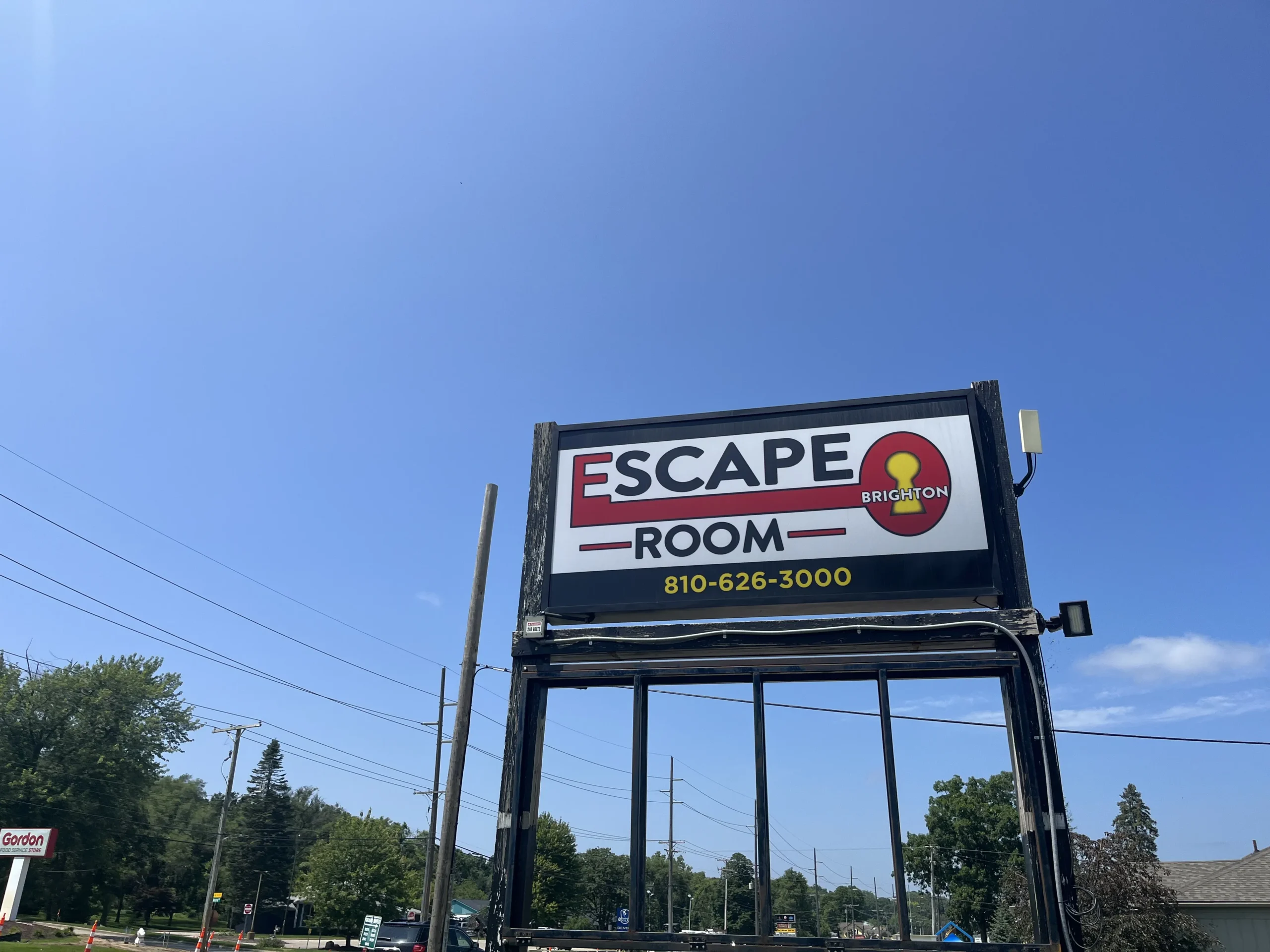 Outside sign of Escape Room Brighton clear skys