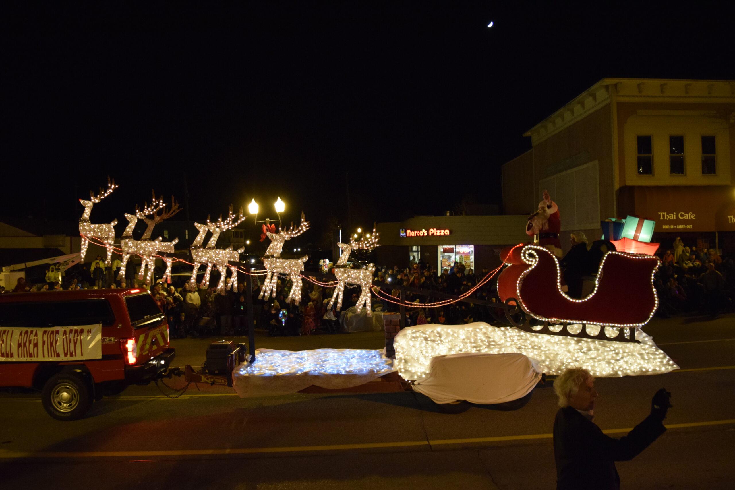 Festival of Lights Christmas float moving throughout downtown Howell, Michigan