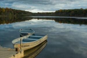 Huron Meadows Metropark metal row boats attached to a floating dock on Maltby lake