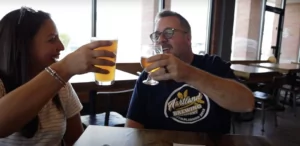 couple cheers beer at hartland brewing co