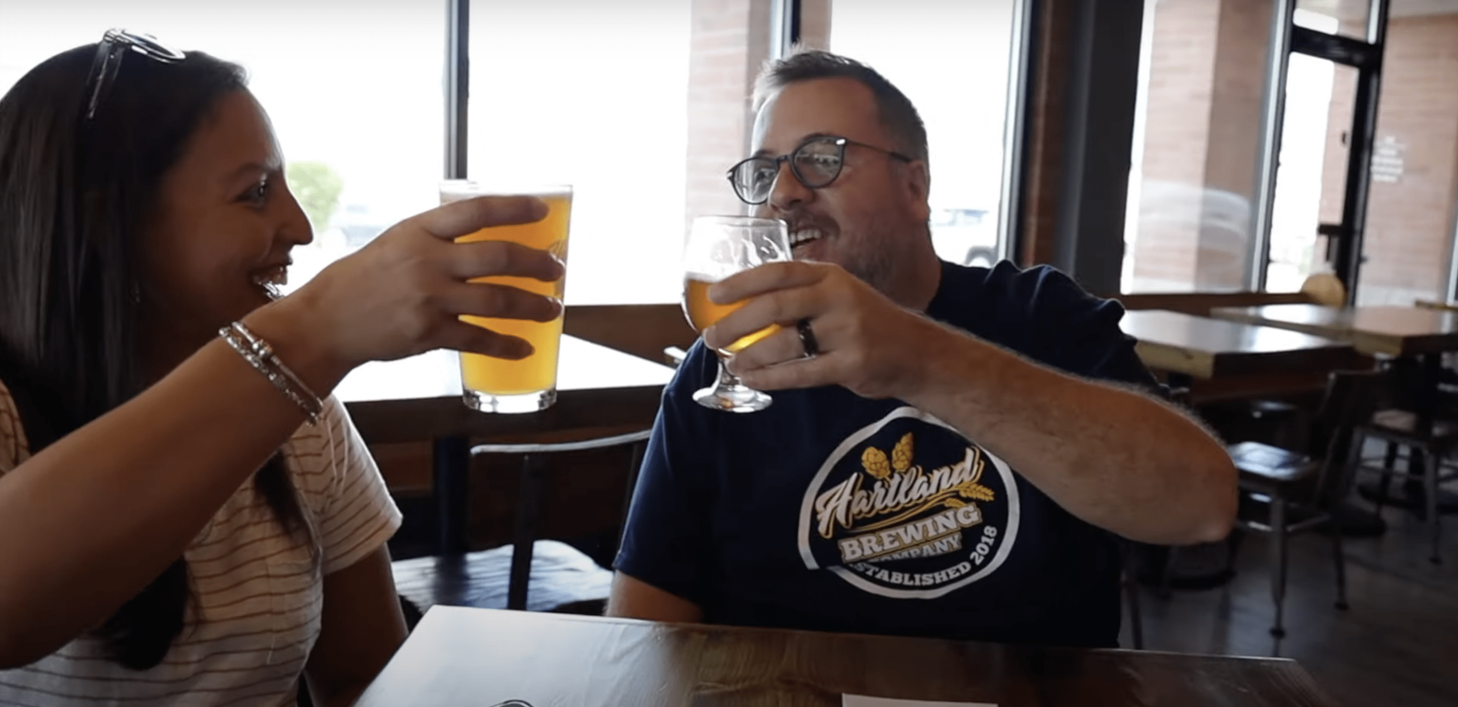 couple cheers beer at hartland brewing co