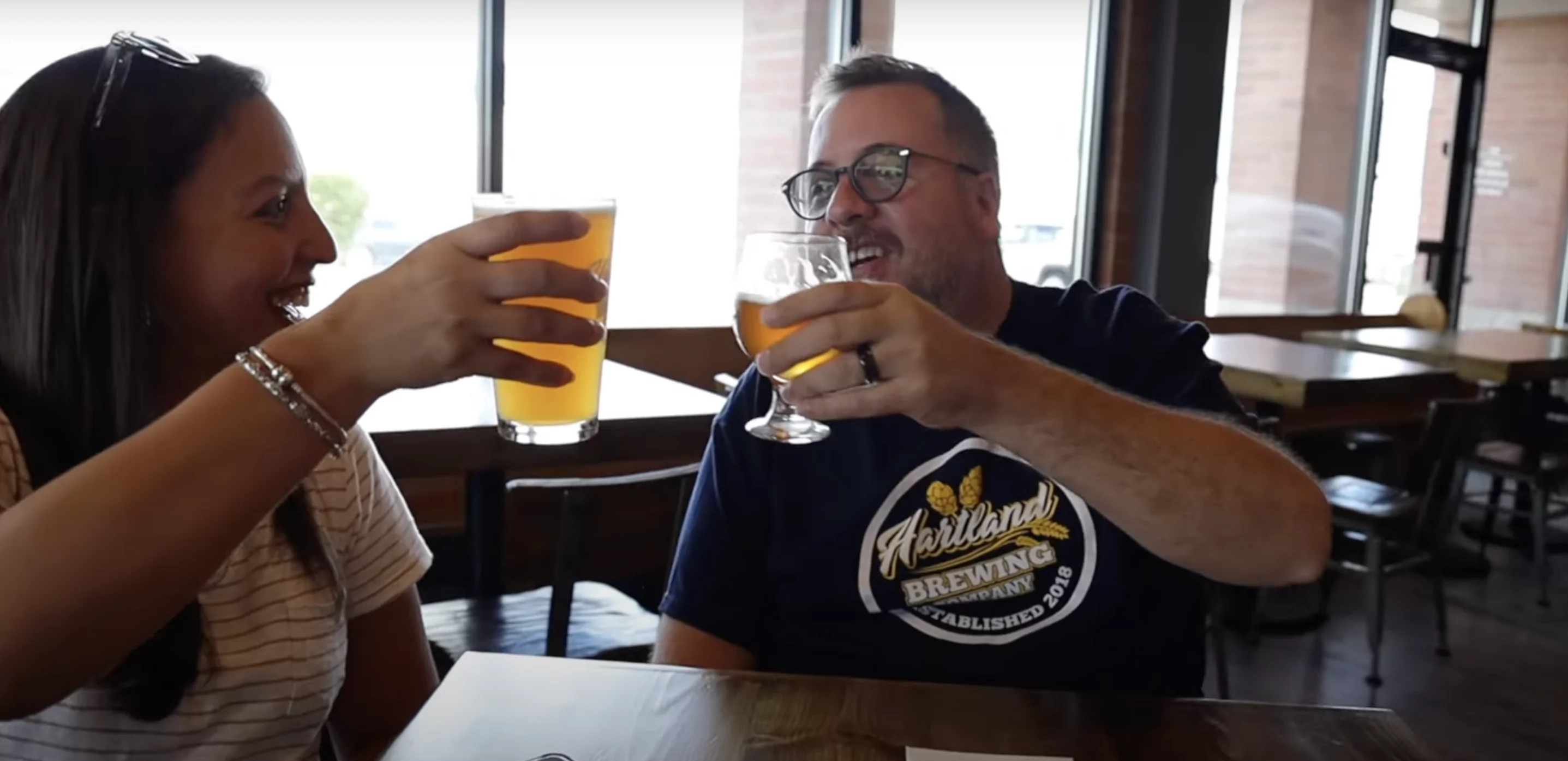 couple cheers beer at hartland brewing co