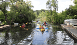 Huron River Water Trail kayaking down the river in lifejackets