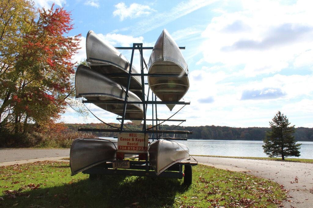 canoe and kayak rentals canoes on shoreline on rack in hell and Picnkney michigan