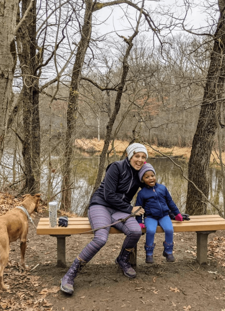 family at island lake recreation area in the fall time on a hike in brighton michigan