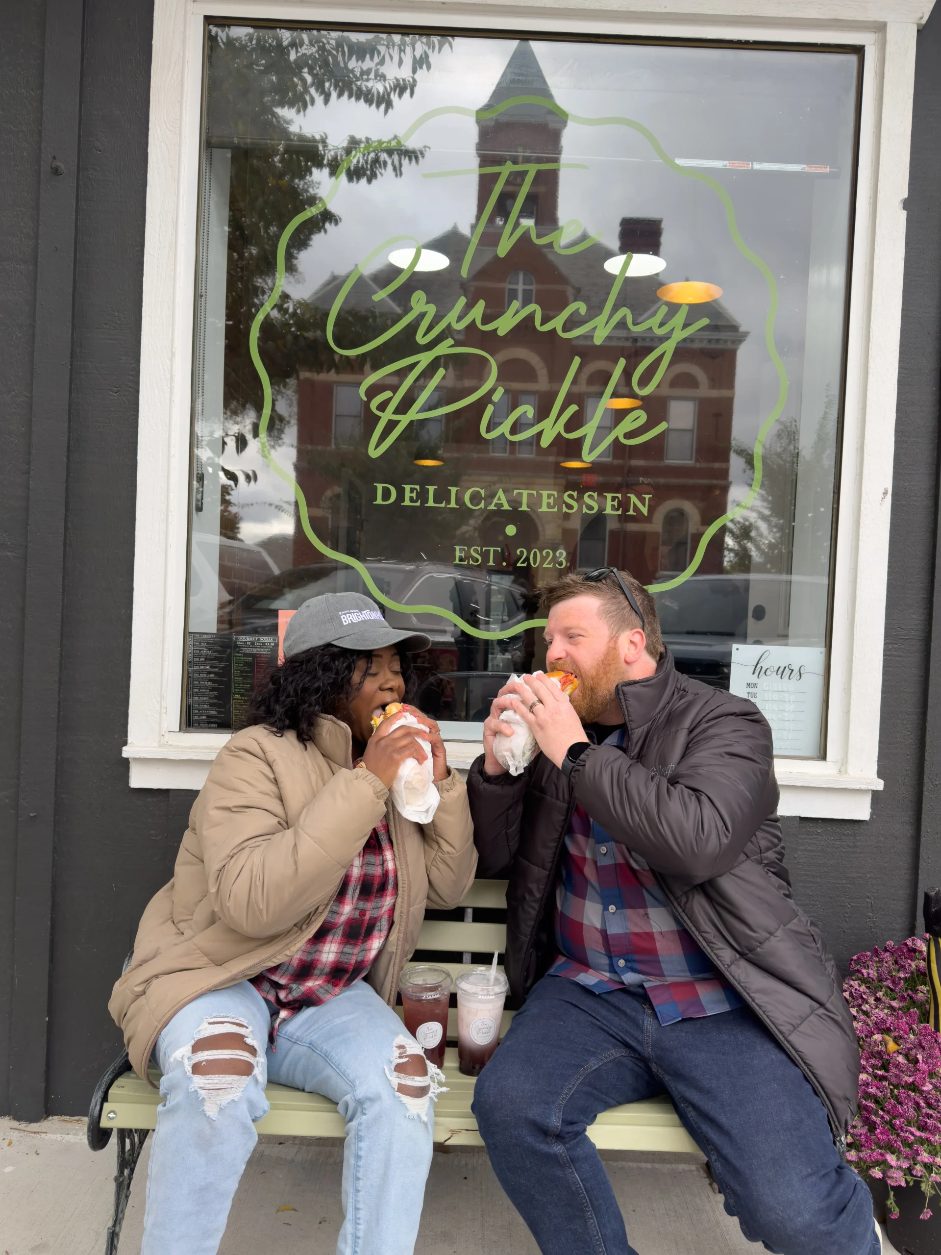 The Crunchy Pickle cute couple eating outside during winter months in downtown Howell.