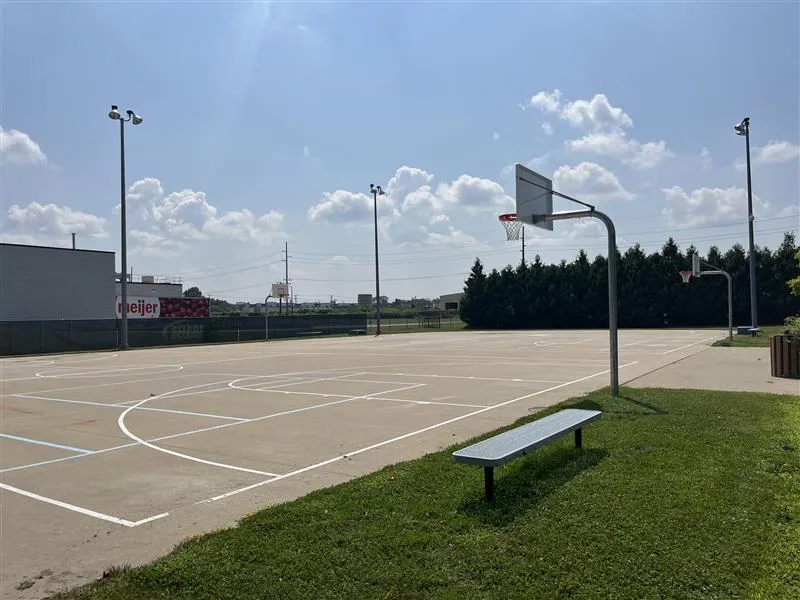 SELCRA Meijer Park basketball court in park with bench in Brighton.