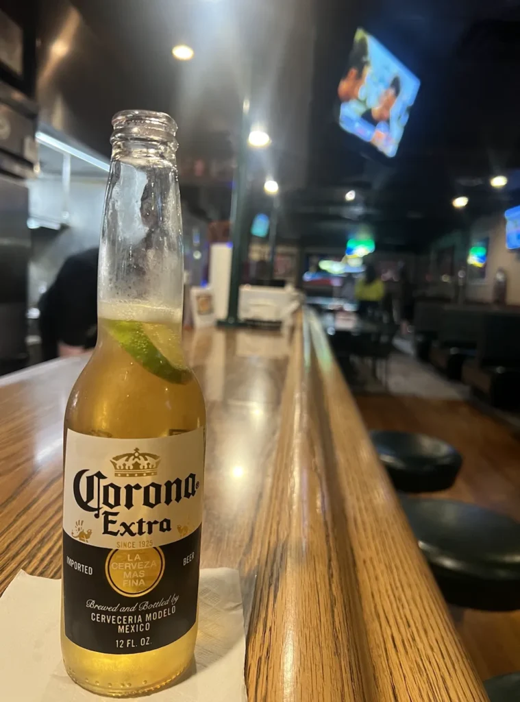 Corona Bottle on wooden bar at Bloated Goat Saloon Fowlerville, Michigan
