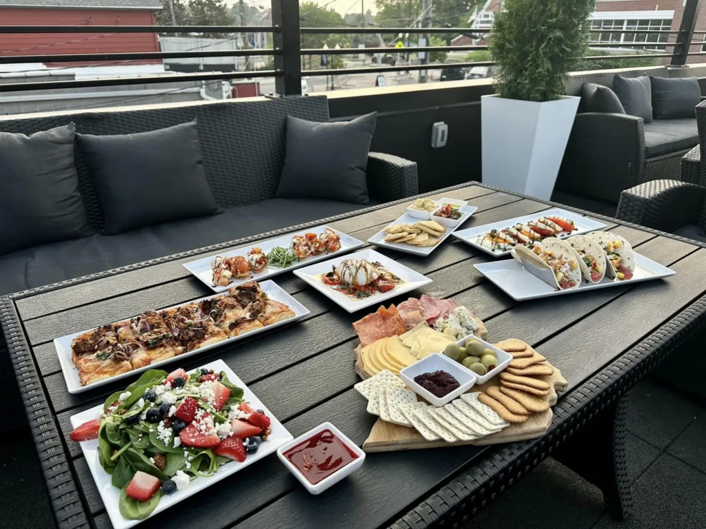 120 West variety of food on tables outside.