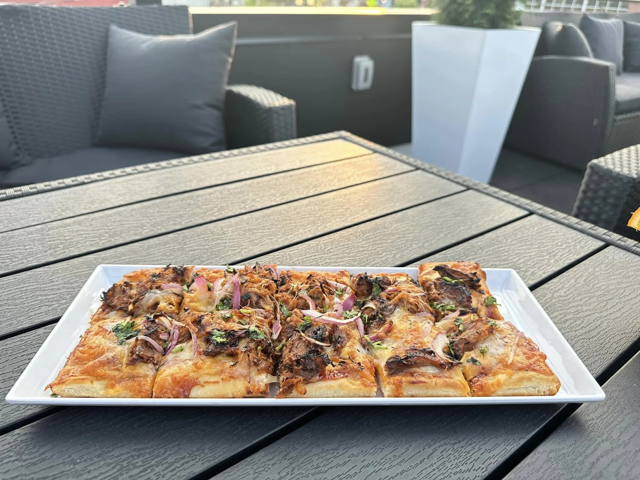 120 West flatbread food on table outside