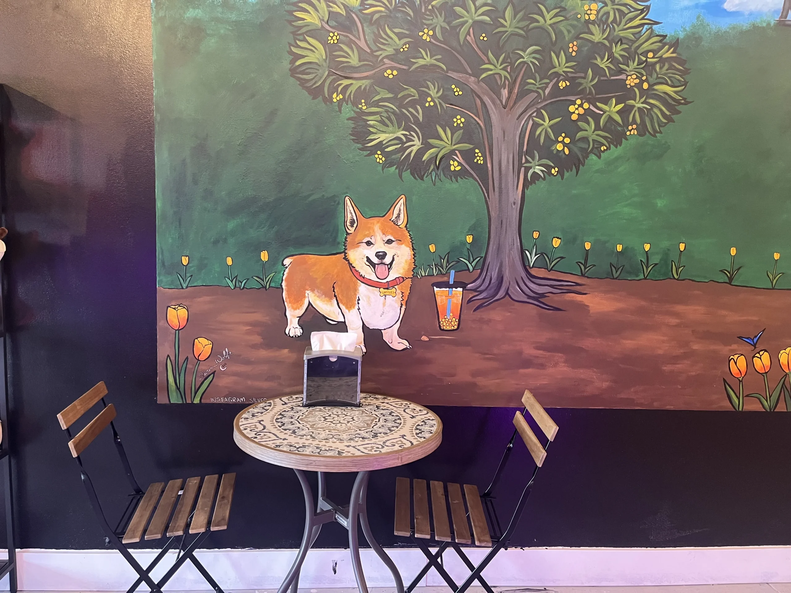 Bolicious Tea cafe area with corgi mural on the wall.