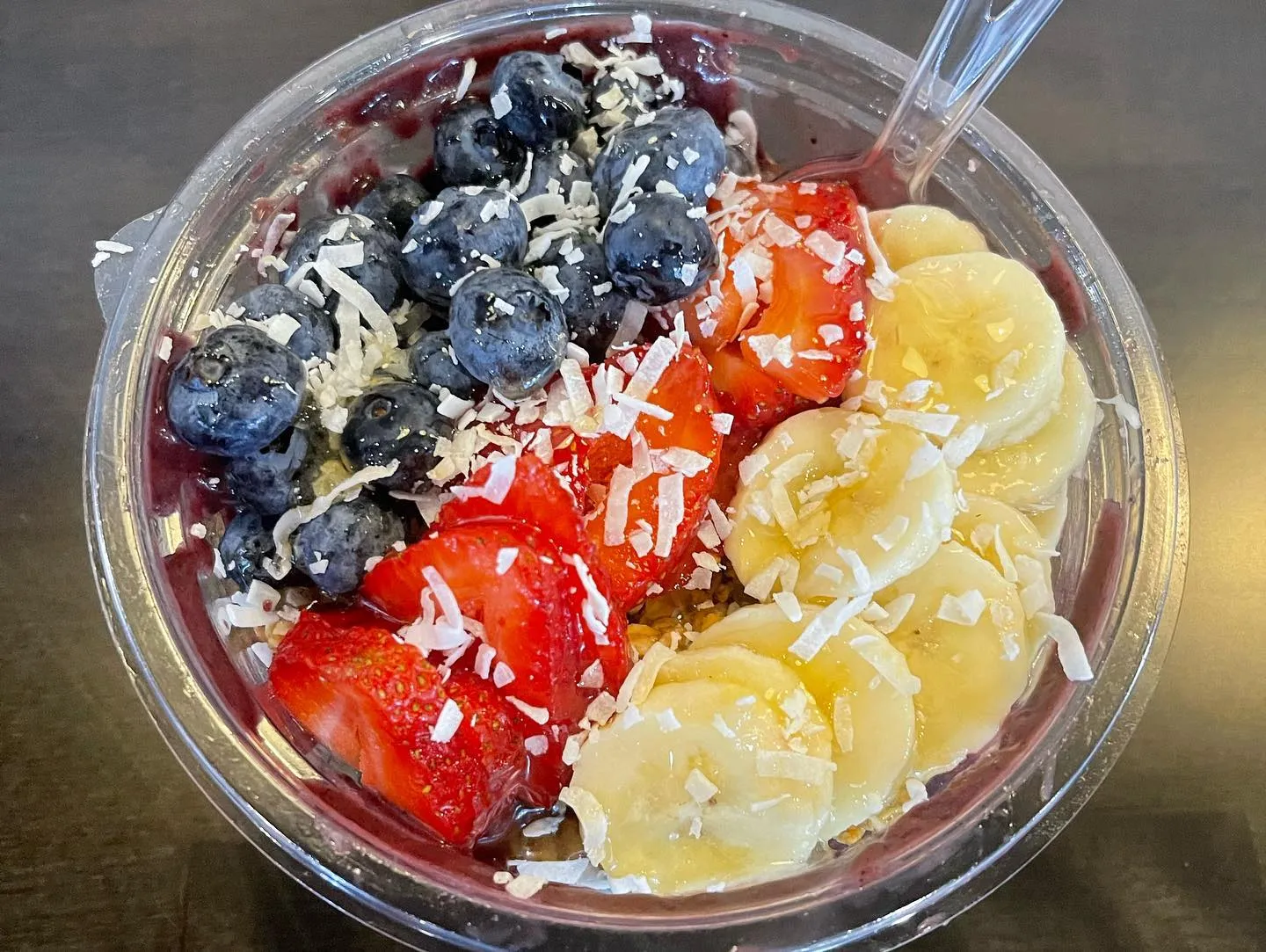 Shaka Cafe acai bowl with different colorful fruits on counter in Howell.