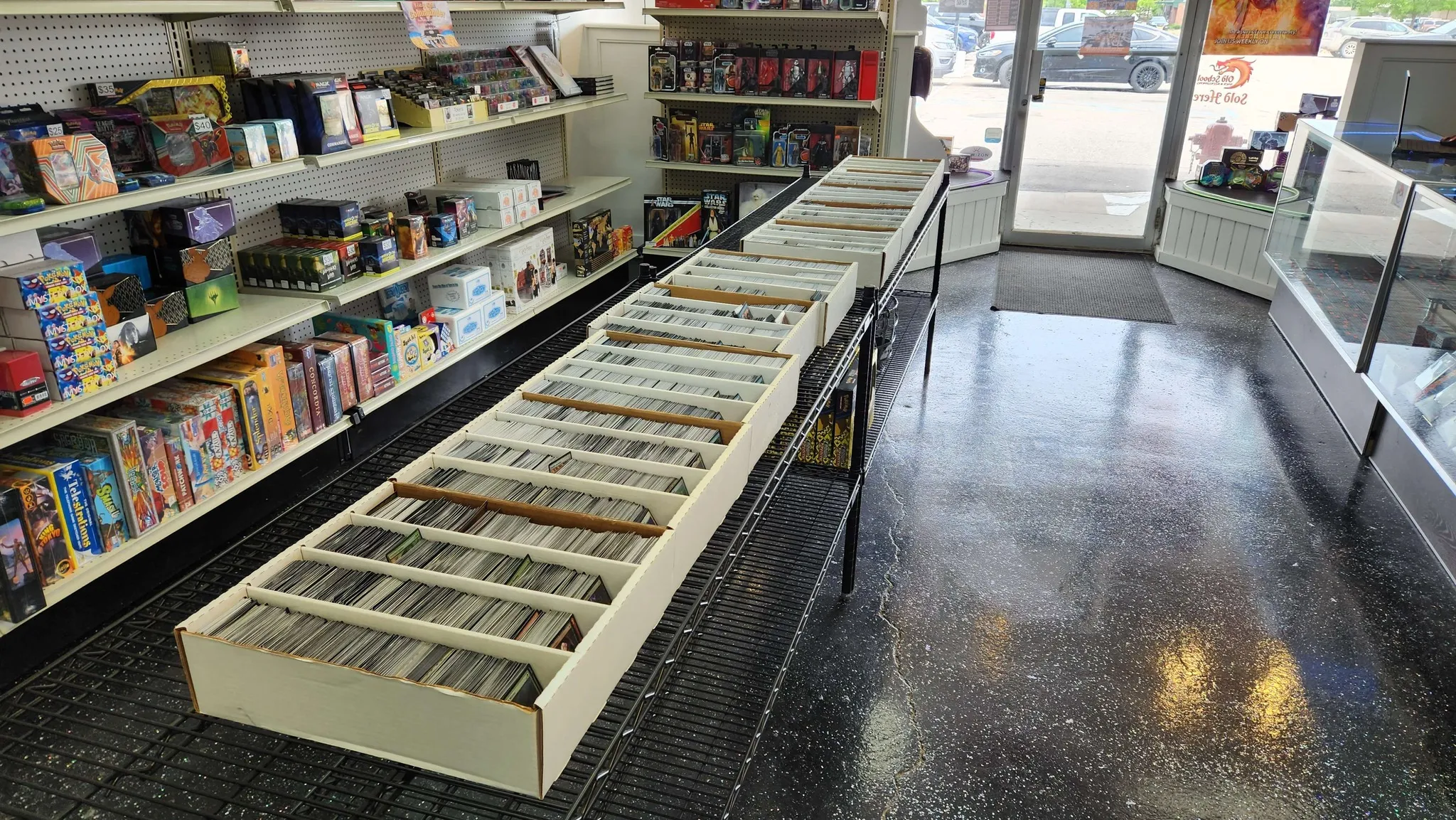 Moms Basement Games cards lined up on the sales floor at gaming store.