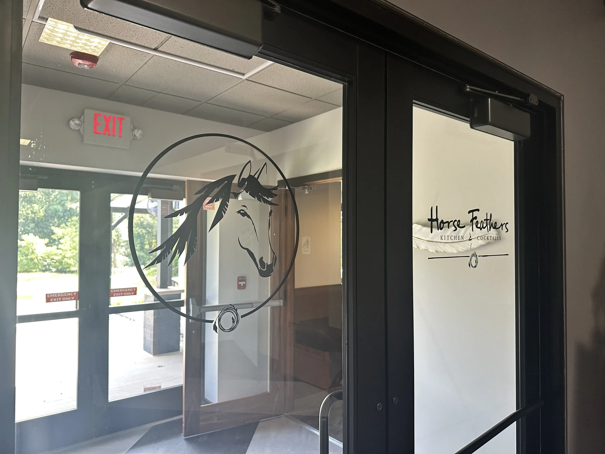 Horse Feathers Kitchen and Cocktails glass door that leads to restaurant space.