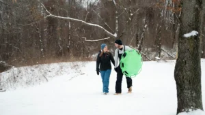 A couple sledding at kensington Metropark