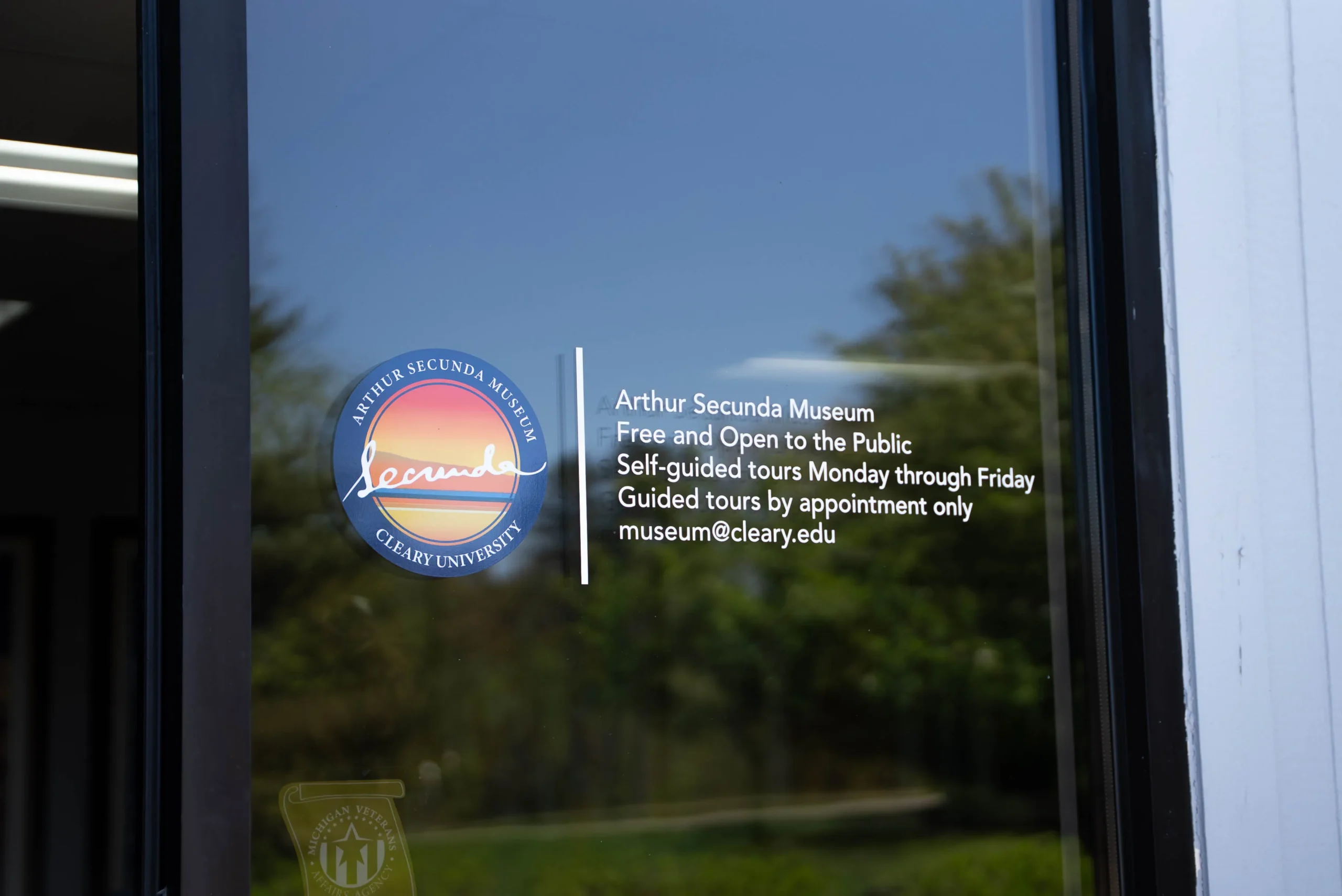 Arthur Secunda Museum museum sign in Howell on glass door.