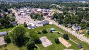 Fowlerville downtown drone shot from above with park and buildings beneath.