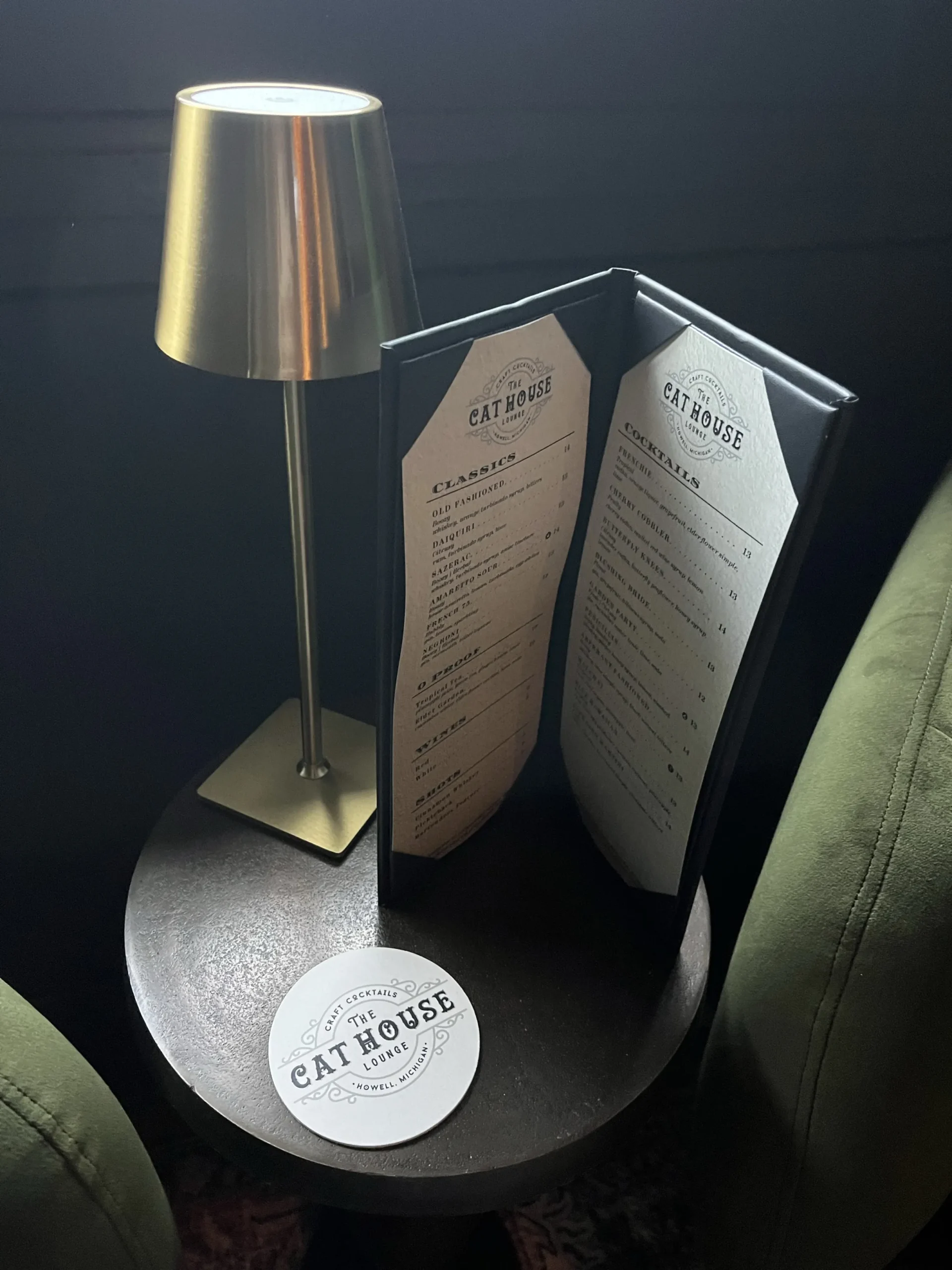 Cat House Lounge menu and coaster on table in howell.