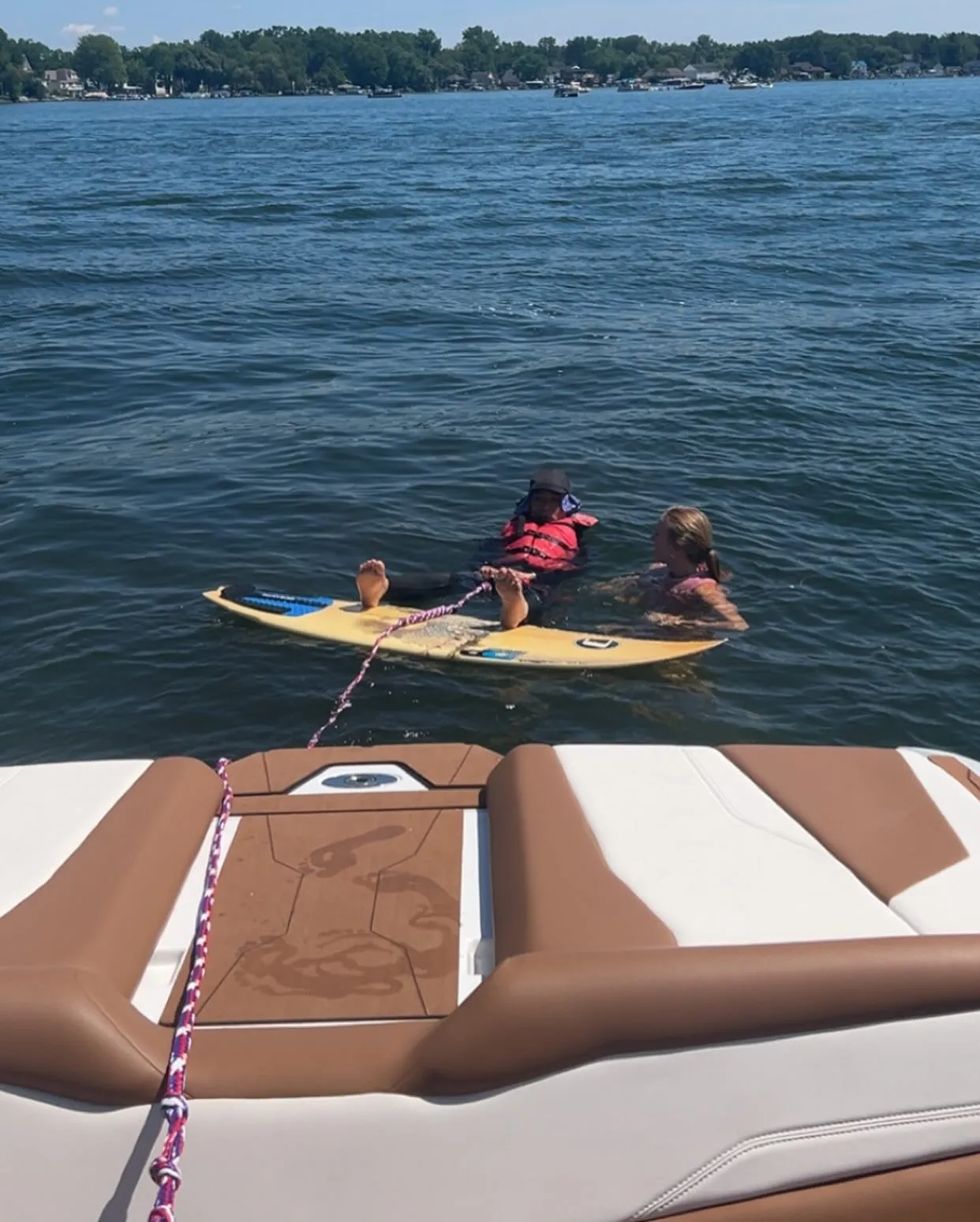 Surf Republic Whitmore Lake view of surfer beind the boat surfing.