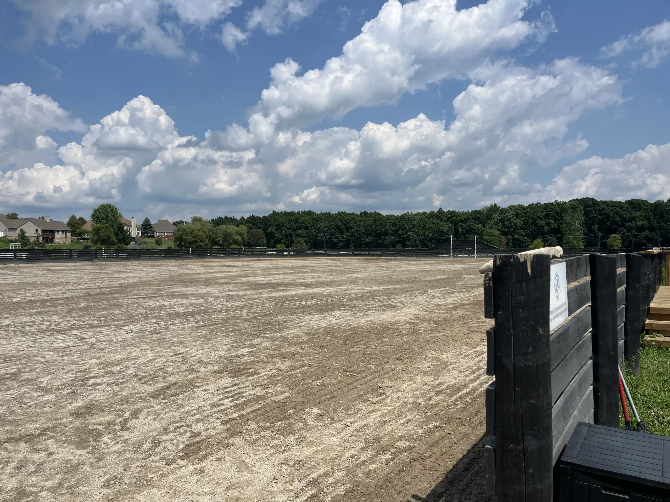 Detroit Polo Club arena view in Hartland with blue sky and clouds.