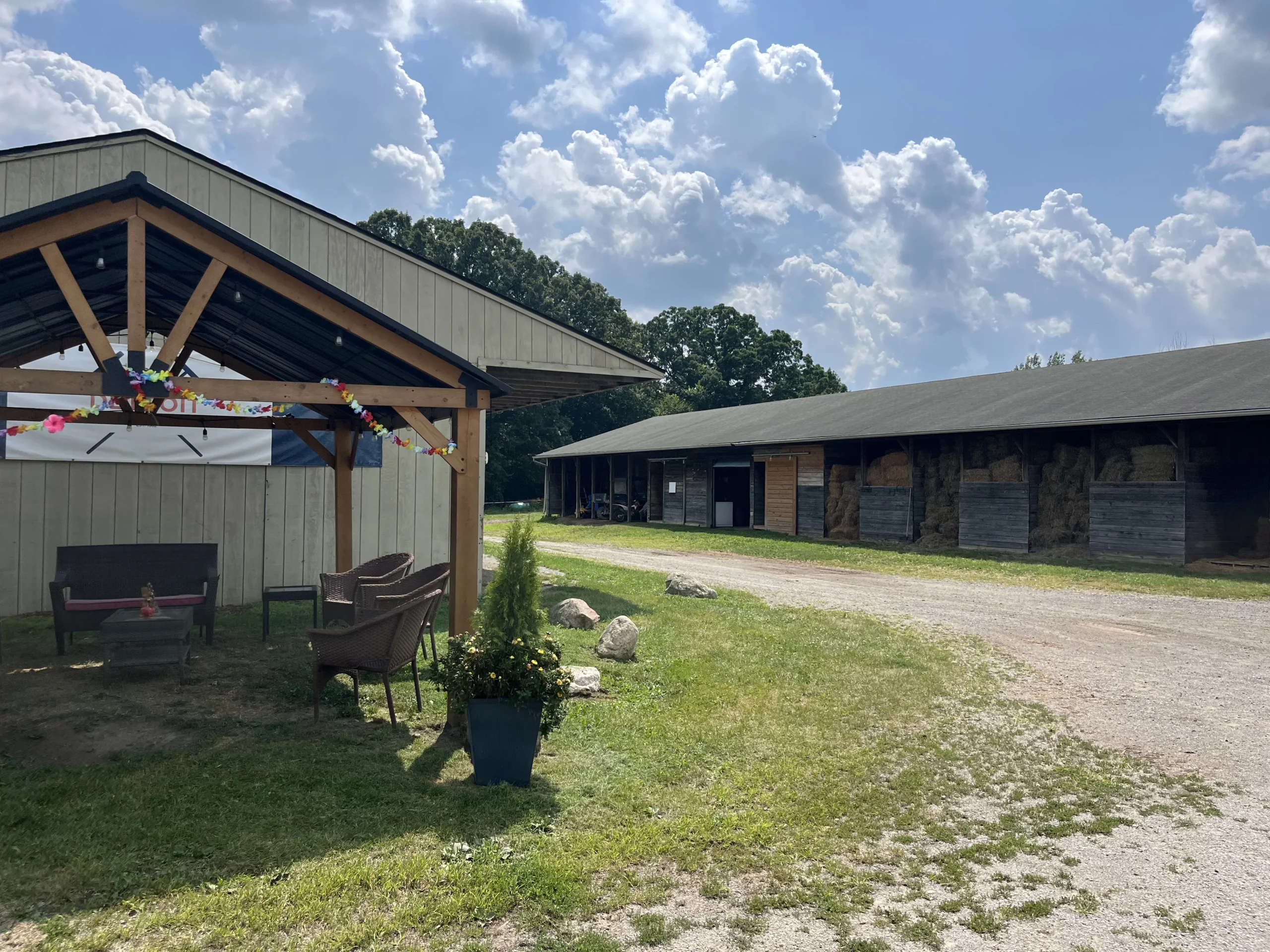 Detroit Polo Club view of stalls and seating area on sunny day in hartland.